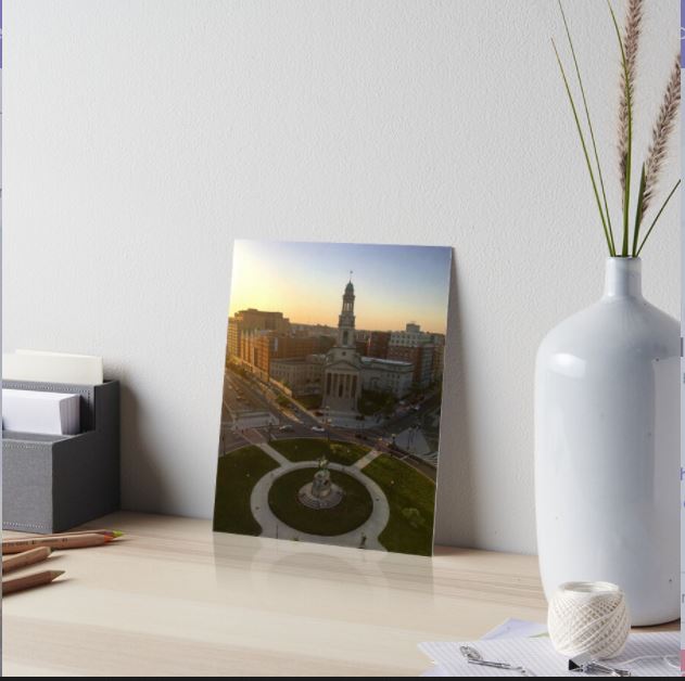 Photo shows a picture of art (a photo) on a desk to show how the art may look inside someone's home